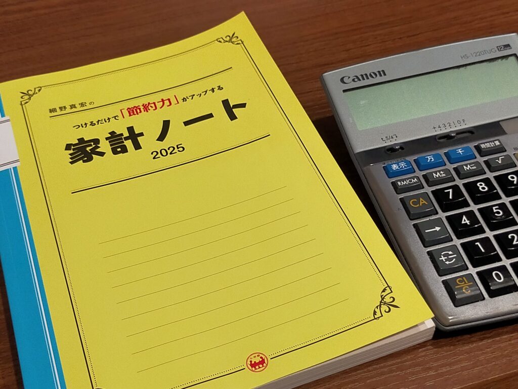 家計ノートと電卓が写っている